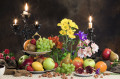 Nature morte de fruits, de fleurs et de bougies