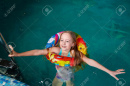 180560694-nice-child-swiming-in-blue-small-pool-girl-have-fun-in-water-indoors