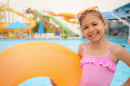172867913-cute-little-girl-with-inflatable-ring-near-pool-in-water-park