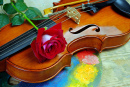 Composition avec un violon et une rose rouge